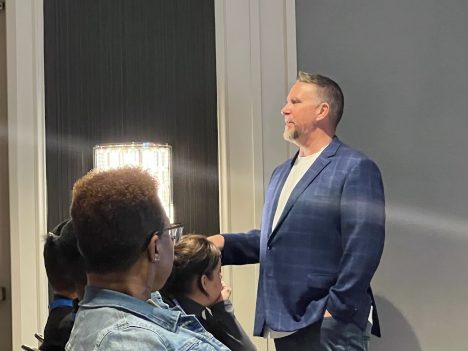 Jack speaking with a group in a training room